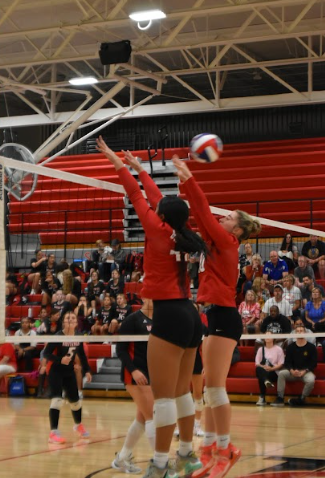 Elaina Noaese and Halle DePeralta go up for a block against Campbell Middle School at home.